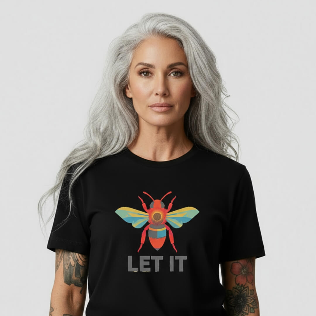 Woman wearing a black t-shirt with a colorful bee design and 'LET IT' text on a white background
